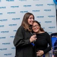 Two girls pose while someone takes their picture